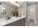 Contemporary bathroom featuring double sinks, modern fixtures, and a large mirror at 2030 Branched Oak Rd, St Cloud, FL 34771