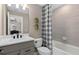 Bright bathroom with a neutral palette, including a toilet, tub/shower combo, and gray vanity at 2030 Branched Oak Rd, St Cloud, FL 34771