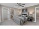 Comfortable bedroom featuring neutral tones, soft lighting, and well-placed mirrors for added depth and style at 2030 Branched Oak Rd, St Cloud, FL 34771