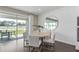 Bright dining area with round table, stylish chairs, shiplap wall, and sliding glass doors to the outdoor space at 2030 Branched Oak Rd, St Cloud, FL 34771