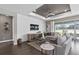 Bright living room featuring modern furnishings, a shiplap wall, and large windows with view of the backyard at 2030 Branched Oak Rd, St Cloud, FL 34771