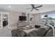 Cozy living room featuring a stylish ceiling fan, comfortable gray sectional, and bright natural lighting at 2030 Branched Oak Rd, St Cloud, FL 34771