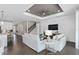 Inviting living room with cozy sofas, a modern ceiling fan, shiplap accent wall, and an open staircase at 2030 Branched Oak Rd, St Cloud, FL 34771