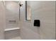 Elegant shower with neutral tile, a built-in bench, a shower niche, and sleek black fixtures at 2030 Branched Oak Rd, St Cloud, FL 34771