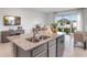 Bright open kitchen featuring a granite island with sink and stainless steel dishwasher at 2124 Monteverde, Davenport, FL 33896