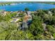 Aerial view of lakefront property showcasing the home, pool, and lush landscaping at 235 Nob Hill Cir, Longwood, FL 32779