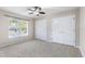 Bright bedroom with carpet, large windows, and double-door closets at 235 Nob Hill Cir, Longwood, FL 32779