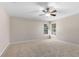 Neutral bedroom with carpet, base molding, and two double-hung windows at 235 Nob Hill Cir, Longwood, FL 32779