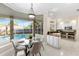 Bright breakfast nook overlooks a screened-in pool and modern kitchen with stainless steel appliances at 235 Nob Hill Cir, Longwood, FL 32779