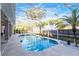 Sparkling pool with a screen enclosure, surrounded by lush landscaping and palm trees at 235 Nob Hill Cir, Longwood, FL 32779