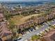 A high-angle shot of a suburban neighborhood showcases uniform townhomes, green spaces, and organized street parking at 2511 Calabria Ave, Davenport, FL 33897