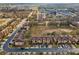 Overhead shot of a community featuring organized townhomes, a central green space, and easy access to parking at 2511 Calabria Ave, Davenport, FL 33897