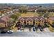 An aerial view highlights a residential development featuring townhomes with landscaping and accessible parking spots at 2511 Calabria Ave, Davenport, FL 33897