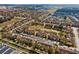 Aerial view of a suburban neighborhood with neatly arranged townhomes, green spaces, and convenient street parking at 2511 Calabria Ave, Davenport, FL 33897