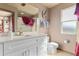 Bright bathroom featuring a white vanity, quartz countertop, and a framed mirror at 2511 Calabria Ave, Davenport, FL 33897