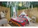 This themed bedroom features a cozy teepee, bamboo accents, and whimsical hanging vines at 2511 Calabria Ave, Davenport, FL 33897