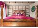 Close-up of the bed in the bedroom, highlighting the decorative headboard and bedding at 2511 Calabria Ave, Davenport, FL 33897