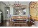 Stylish dining area with a wooden table, and unique decor, with the open concept kitchen in the background at 2511 Calabria Ave, Davenport, FL 33897