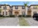 Townhome with brick paved driveway and lush landscaping at 2511 Calabria Ave, Davenport, FL 33897