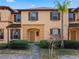 Charming townhome exterior features a brick pathway, well-maintained landscaping, and a welcoming facade at 2511 Calabria Ave, Davenport, FL 33897