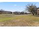 Spacious grassy area surrounding multi-unit home with a beautiful tree at 2511 Calabria Ave, Davenport, FL 33897