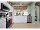 Well-equipped kitchen with white cabinets, stainless steel appliances and view of the living room at 2511 Calabria Ave, Davenport, FL 33897