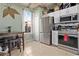 Cozy kitchen with white cabinets, stainless steel appliances, breakfast table and modern tiled backsplash at 2511 Calabria Ave, Davenport, FL 33897