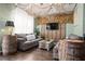 Spacious living room featuring themed decor, with wooden barrel accents, comfortable seating, and unique lighting at 2511 Calabria Ave, Davenport, FL 33897