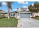 Charming two-story home with a well-manicured lawn and a two-car garage at 2570 Chatham Cir, Kissimmee, FL 34746