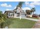 Beautifully landscaped two-story home with mature trees and a spacious front yard at 2570 Chatham Cir, Kissimmee, FL 34746