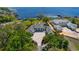 Aerial view of stunning home on the water, showcasing the lush greenery and beautiful landscaping at 3120 Downs Cove Rd, Windermere, FL 34786