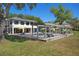 Exterior view of the home's backyard featuring a pool, patio, and lakeside view at 3120 Downs Cove Rd, Windermere, FL 34786