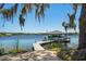 Boat dock with a boat and a green lawn at 3120 Downs Cove Rd, Windermere, FL 34786