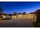 Elegant home with a circular driveway, a multi-car garage, and exterior illumination at 3120 Downs Cove Rd, Windermere, FL 34786