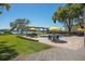 Gorgeous pool area featuring a covered lounge area, yellow umbrellas, and brick pavers at 3120 Downs Cove Rd, Windermere, FL 34786