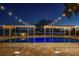 Beautiful swimming pool at night with string lights, pergola, and lake view at 3120 Downs Cove Rd, Windermere, FL 34786