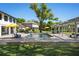 Gorgeous pool area featuring a covered lounge area, yellow umbrellas, and brick pavers at 3120 Downs Cove Rd, Windermere, FL 34786