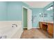 Bathroom offering a tiled floor, vanity, and relaxing tub at 3200 Utah Dr, Deltona, FL 32738