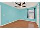 Bedroom featuring hardwood floors, light blue walls, natural light, ceiling fan, and neutral trim at 3200 Utah Dr, Deltona, FL 32738