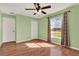 Bright bedroom with hardwood floors, large window, ceiling fan at 3200 Utah Dr, Deltona, FL 32738