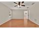 Bright bedroom showcasing a ceiling fan, laminate floors and seamless transition to the bathroom at 3200 Utah Dr, Deltona, FL 32738