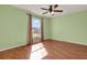 Comfortable bedroom with hardwood floors, large window, and fan at 3200 Utah Dr, Deltona, FL 32738