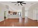 Spacious living room featuring sleek wood floors, an open layout, and modern ceiling fan, creating a comfortable gathering space at 3200 Utah Dr, Deltona, FL 32738