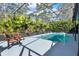 Inviting screened pool area with clear water and relaxing wicker chairs at 3200 Utah Dr, Deltona, FL 32738