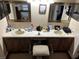 Bathroom featuring double sinks with a vanity in between, each with framed mirrors above at 3220 Town And Country Rd, Oviedo, FL 32766