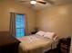 Cozy bedroom features a ceiling fan and window with natural light at 3220 Town And Country Rd, Oviedo, FL 32766