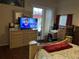 View of bedroom showcasing a TV on a dresser, with a sliding glass door in the background at 3220 Town And Country Rd, Oviedo, FL 32766