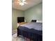 Bedroom features a large bed, ceiling fan, and a TV on a dresser at 3220 Town And Country Rd, Oviedo, FL 32766