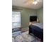 Bedroom features a grey bed spread, a ceiling fan, neutral wall color and a window at 3220 Town And Country Rd, Oviedo, FL 32766