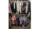 Organized closet with hanging clothes in various colors and styles at 3220 Town And Country Rd, Oviedo, FL 32766